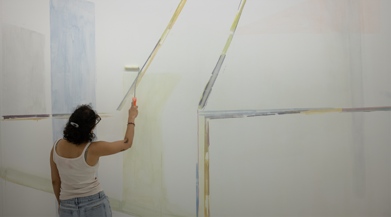 Nanaki creating an artwork directly on the walls of Gallery 1 for her graduation showcase.