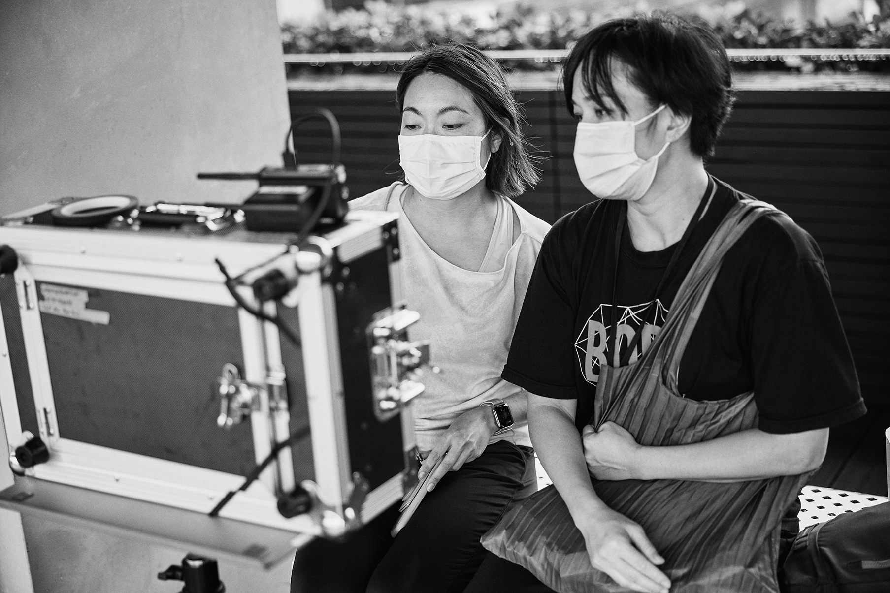 Melissa Quek and Yarra Ileto monitor a recording behind the scenes.
