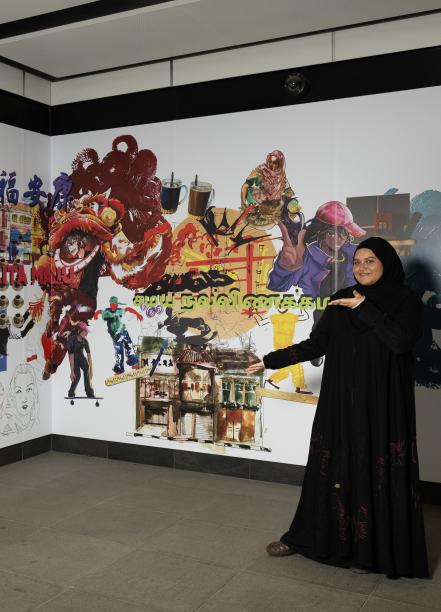 Tiara Choo and Ayra Nasha pose in front of their art at Rochor MRT station.