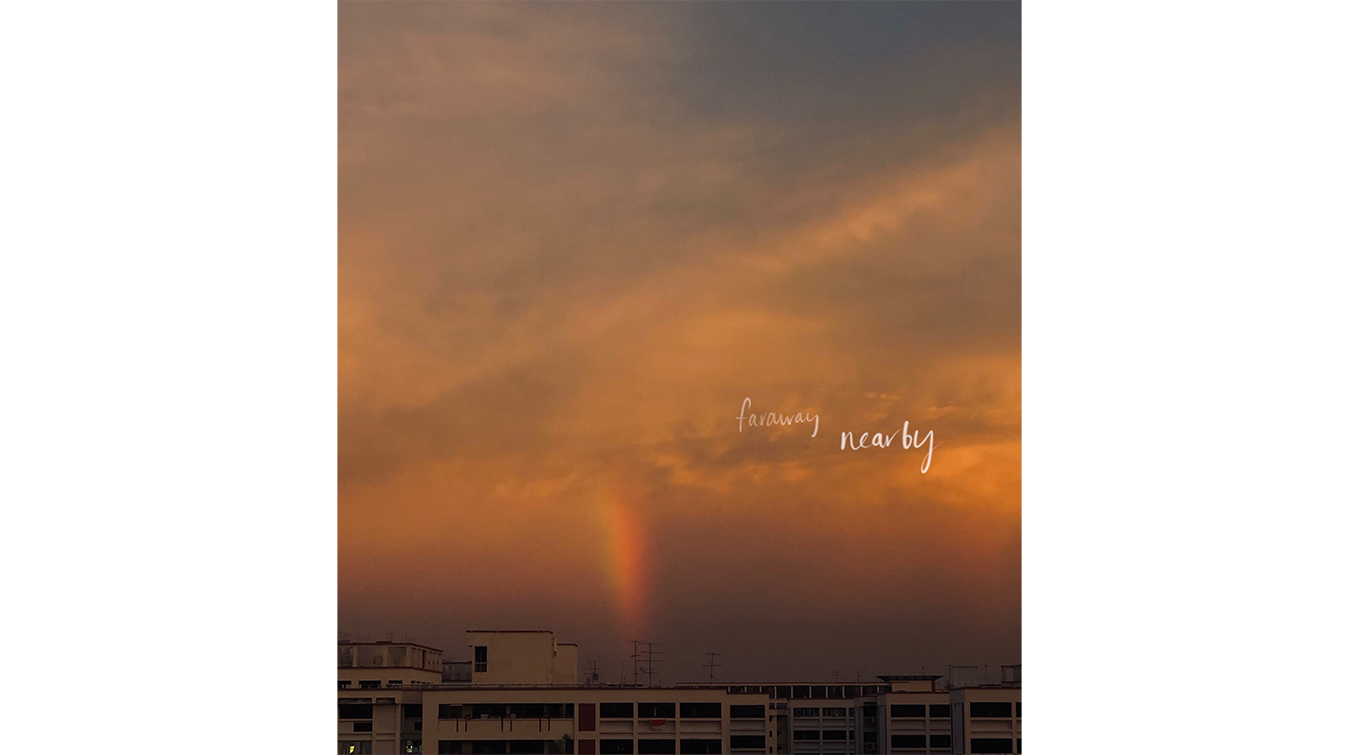 Sky at dusk with a rainbow extending to the earth