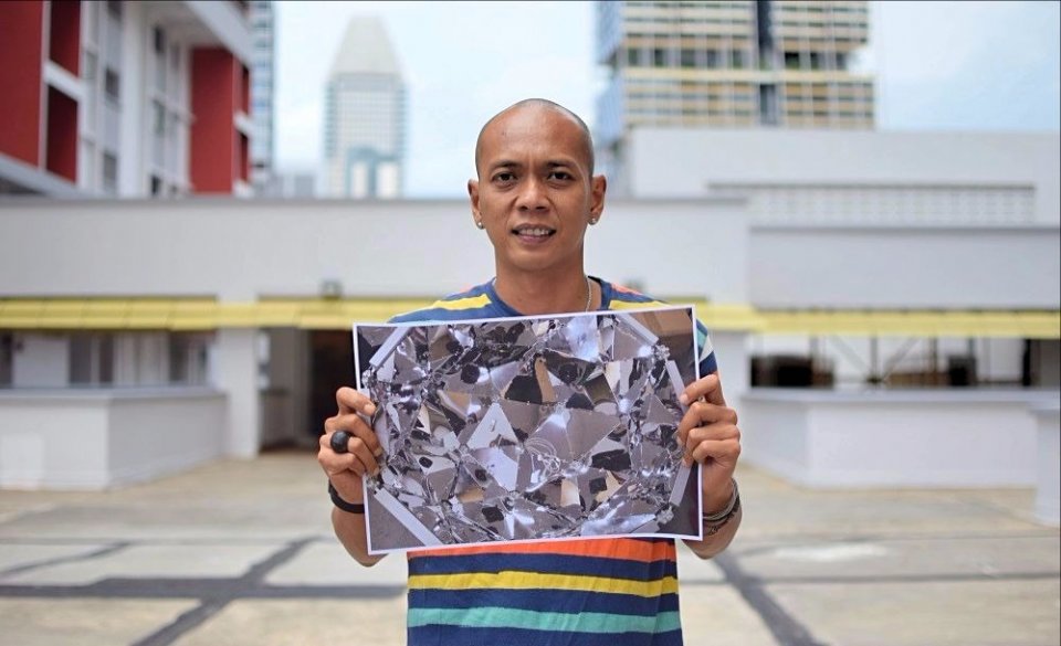 Posing with a work-in-progress image of his work for Singapore Inside Out: Tokyo in 2017. Image credit: SG Magazine.