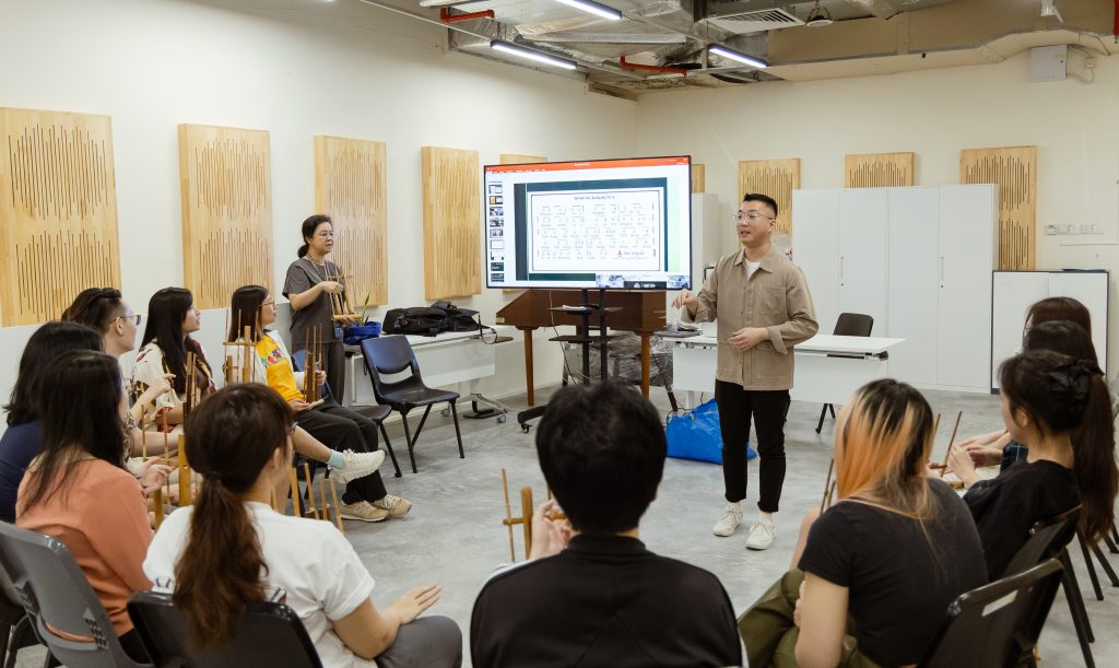 LASALLE MA Music Therapy student Paul Ng Xin Kai keeping time during an angklung exploration session.