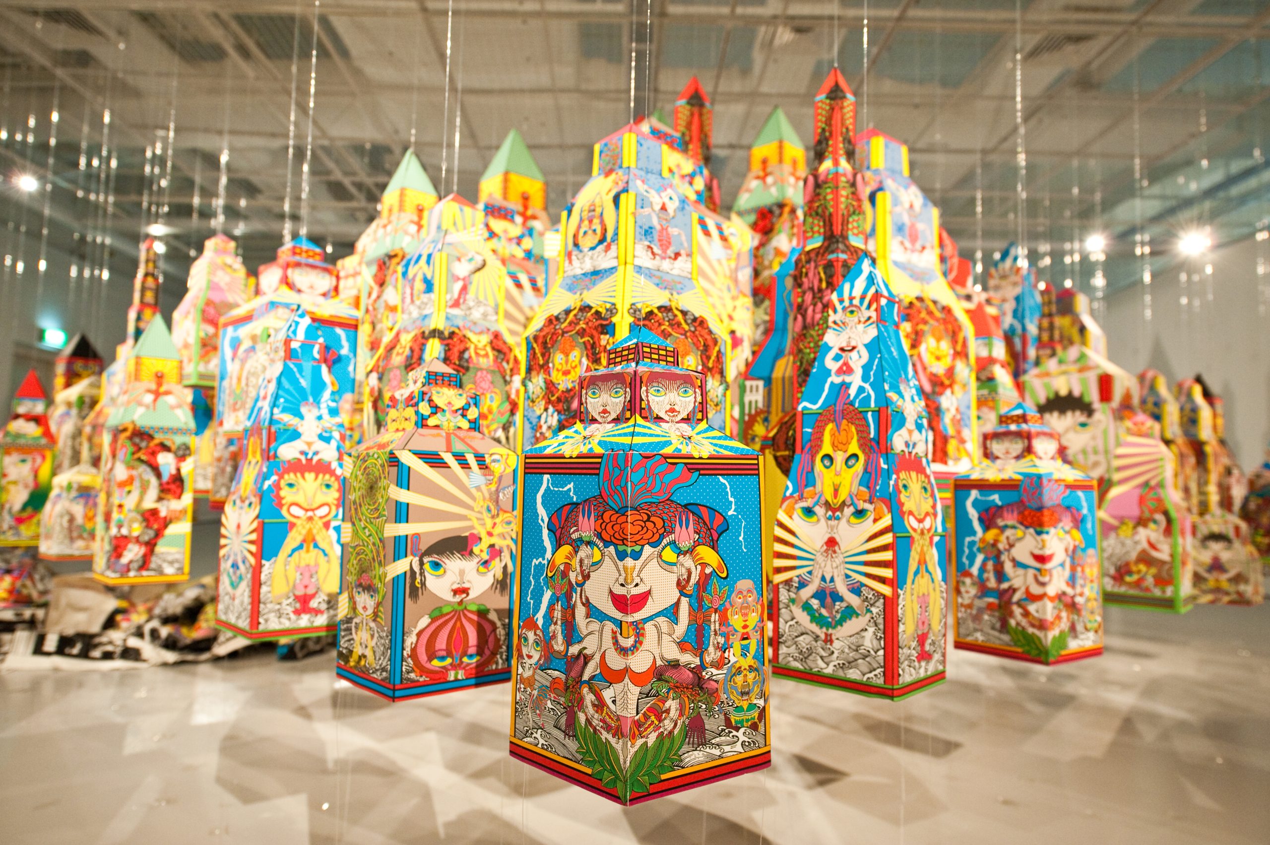 Colourful hanging lantern-like installations with bold cartoon imagery and vivid patterns fill a LASALLE gallery space.