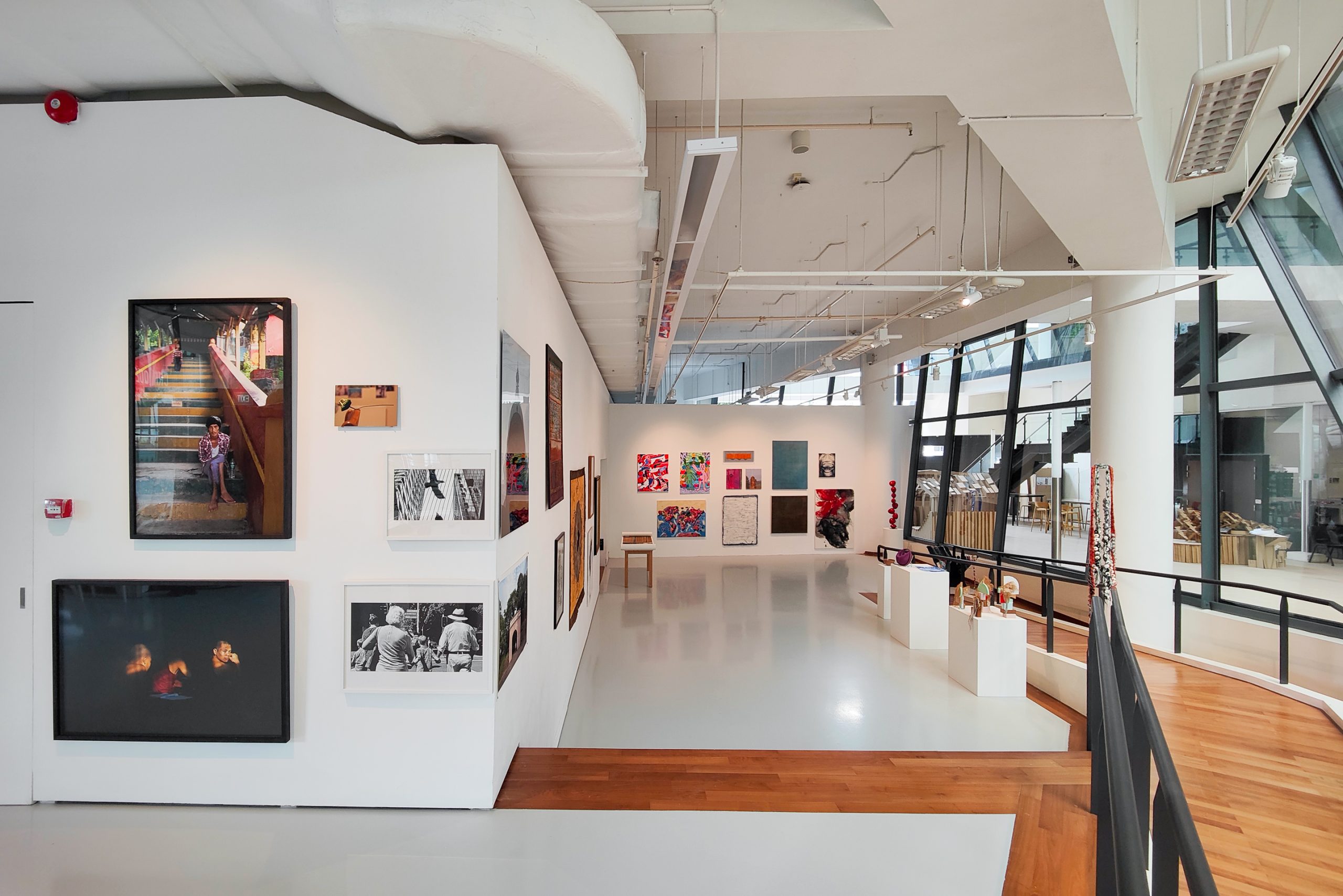 LASALLE gallery with colourful paintings, photographs and sculptures displayed along bright white walls and glass windows.