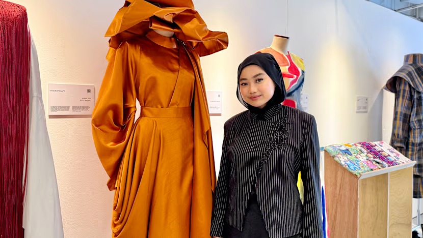 Nurul Izza with one of her designs presented during the fashion show at Cantonment MRT Station (Photo: Fatyn Abdul Samad)