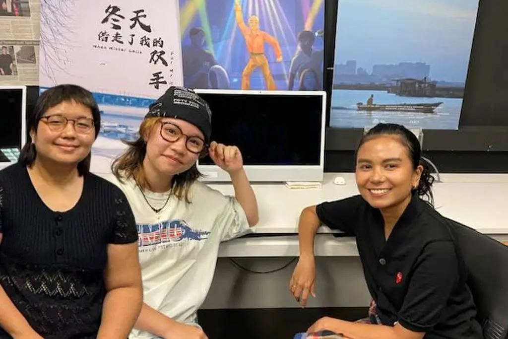 Emma Rose Chow and Pearlyn Kee with Kamila in the classroom.